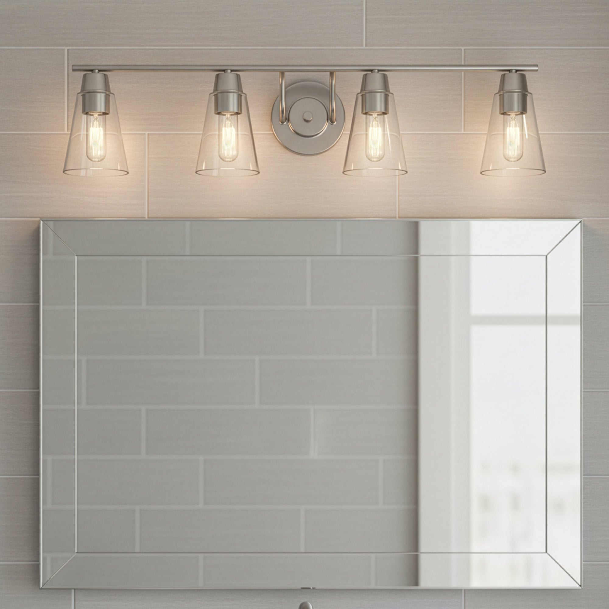 Bathroom mirror with light fixture above it on a tiled wall.